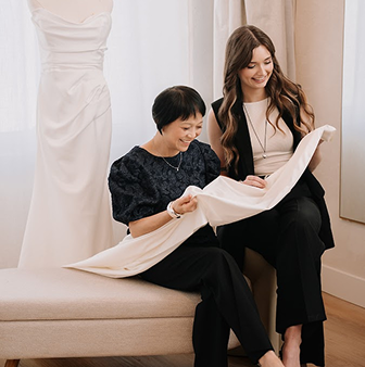 Portrait of a happy bride sitting and posing in her beautifully tailored wedding gown