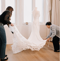 Close up of a bride's wedding dress showing delicate lace back details and perfect fitting
