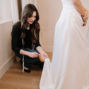 Smiling bride posing outdoors in her wedding dress